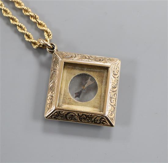 A late Victorian engraved 9ct gold mounted compass pendant, on a later 9k ropetwist chain, compass 27mm.
